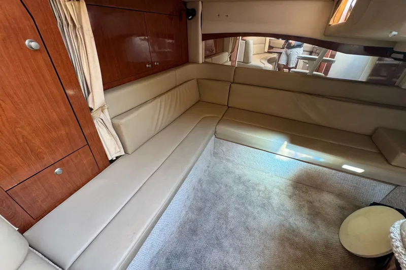 Slide: The Image of Interior of 2006 Sea Ray 340 Sundancer yacht with beige seating and wooden cabinetry. - 69