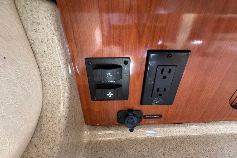 Slide: The Image of Control panel and outlet on 2006 Sea Ray 340 Sundancer boat interior. - 86