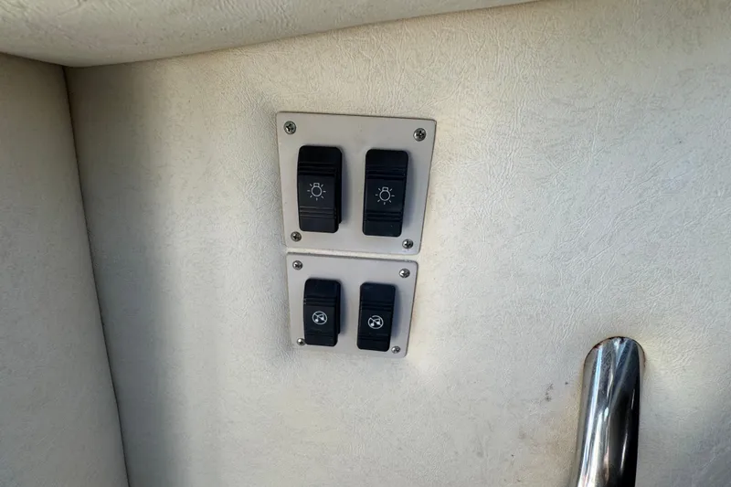 Slide: The Image of Control panel on a 2006 Sea Ray 340 Sundancer boat, featuring switches for lighting and ventilation. - 61