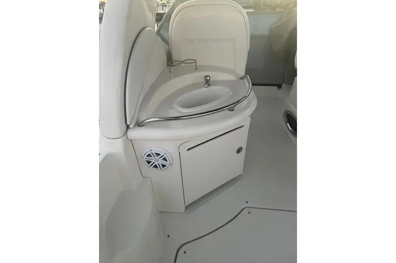 Slide: The Image of 2006 Sea Ray 340 Sundancer boat sink area with storage and speaker. - 15