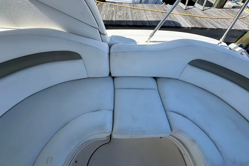 Slide: The Image of 2006 Sea Ray 340 Sundancer boat seating area with white cushioned seats. - 21