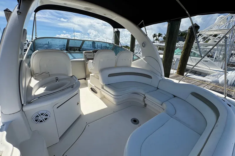 Slide: The Image of 2006 Sea Ray 340 Sundancer boat interior with seating and helm, docked at marina. - 17