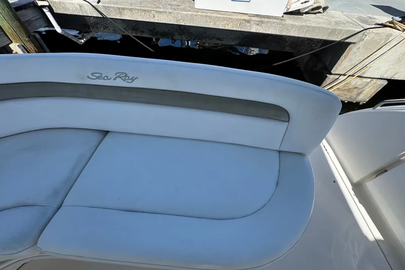 Slide: The Image of 2006 Sea Ray 340 Sundancer boat seat with logo, docked at marina. - 19