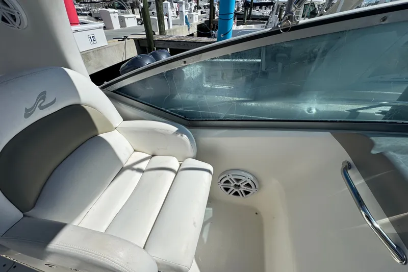 Slide: The Image of Interior of 2006 Sea Ray 340 Sundancer boat with white seating and window view. - 31