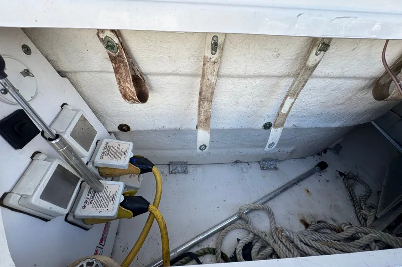 Slide: The Image of Storage compartment of a 2006 Sea Ray 340 Sundancer with shore power connections and ropes. - 15