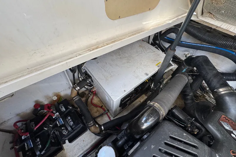 Slide: The Image of Engine compartment of a 2006 Sea Ray 340 Sundancer with visible batteries and wiring. - 103