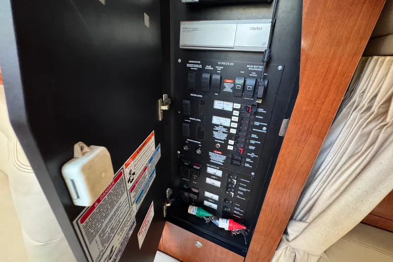Slide: The Image of Electrical panel inside a 2006 Sea Ray 340 Sundancer boat, featuring various switches and controls. - 76