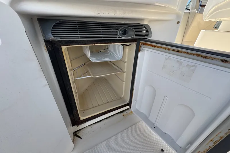Slide: The Image of Open refrigerator on 2006 Sea Ray 340 Sundancer boat, showing interior shelves. - 27