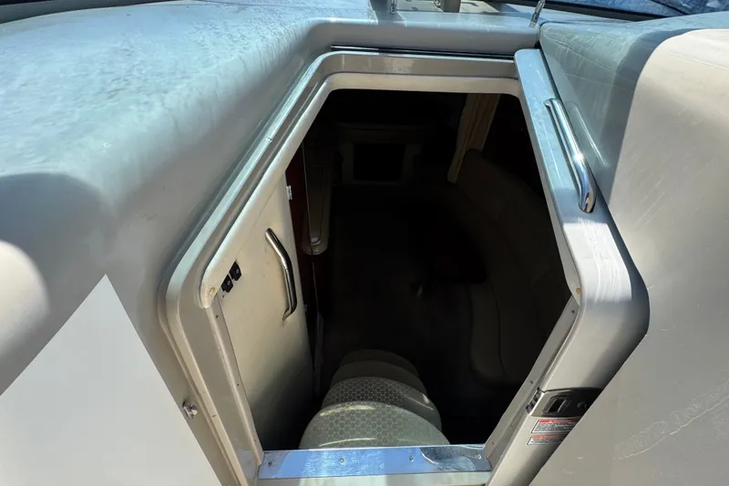 Slide: The Image of Cabin entrance of 2006 Sea Ray 340 Sundancer boat, showing interior seating. - 59