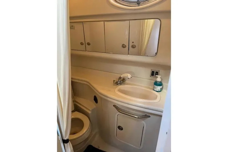 Slide: The Image of 2006 Sea Ray 340 Sundancer bathroom with sink, mirror, and toilet. - 16