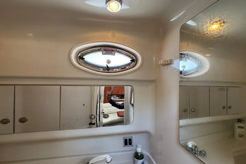 Slide: The Image of Bathroom interior of 2006 Sea Ray 340 Sundancer yacht with oval window and mirror. - 83