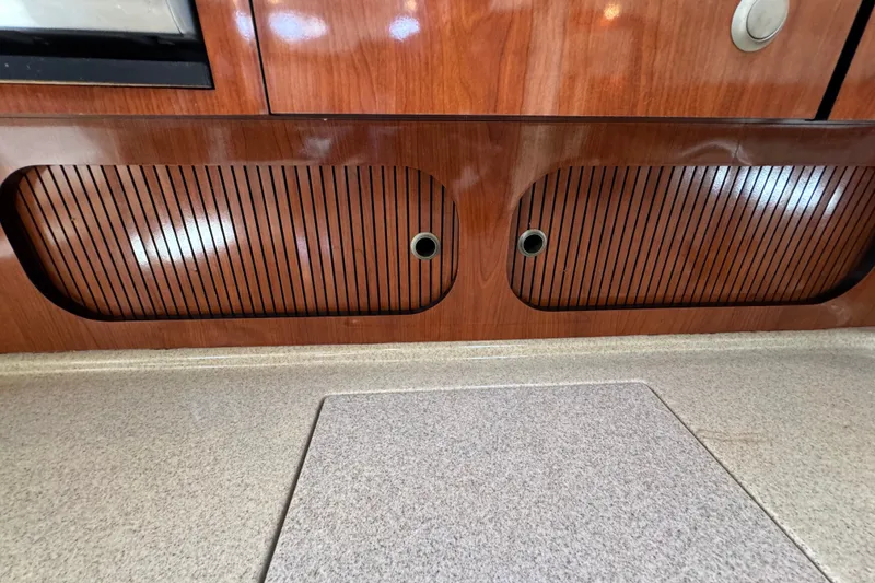 Slide: The Image of Wooden cabinetry and countertop detail on a 2006 Sea Ray 340 Sundancer boat. - 87