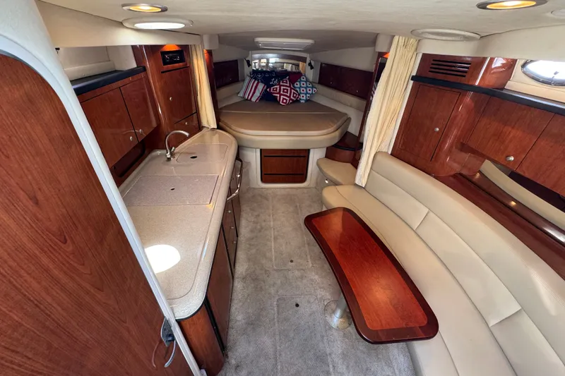 Slide: The Image of 2006 Sea Ray 340 Sundancer interior with elegant wood cabinetry and cozy seating area. - 62