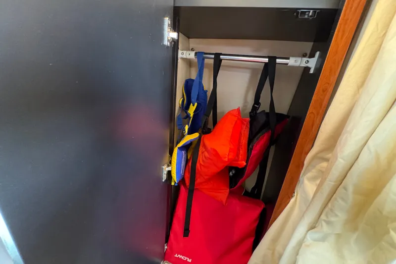 Slide: The Image of Life jackets stored in a 2006 Sea Ray 340 Sundancer boat closet. - 97