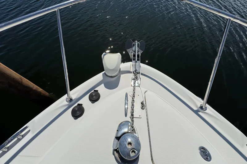 Slide: The Image of Bow of 2006 Sea Ray 340 Sundancer yacht with anchor and railing on calm water. - 51