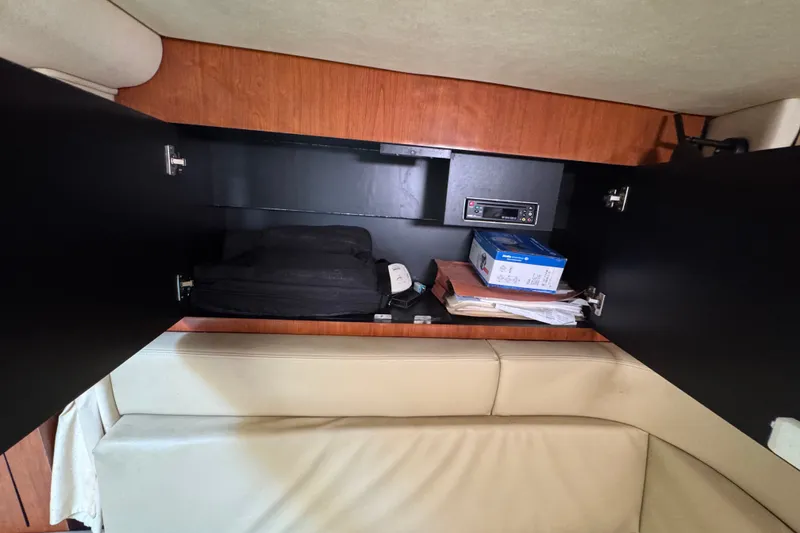 Slide: The Image of Interior storage compartment of 2006 Sea Ray 340 Sundancer boat with various items. - 72