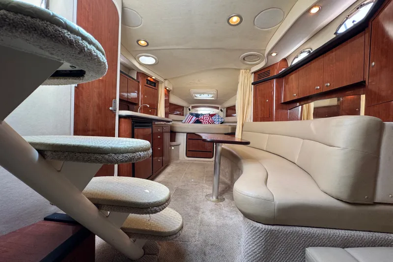 Slide: The Image of Luxurious interior of 2006 Sea Ray 340 Sundancer yacht with plush seating and wooden cabinetry. - 75