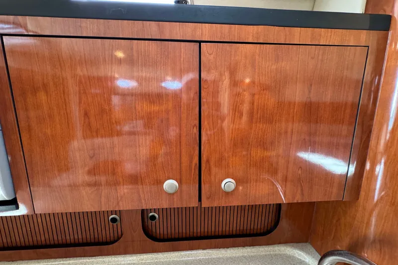 Slide: The Image of Wooden cabinet doors inside a 2006 Sea Ray 340 Sundancer boat. - 89