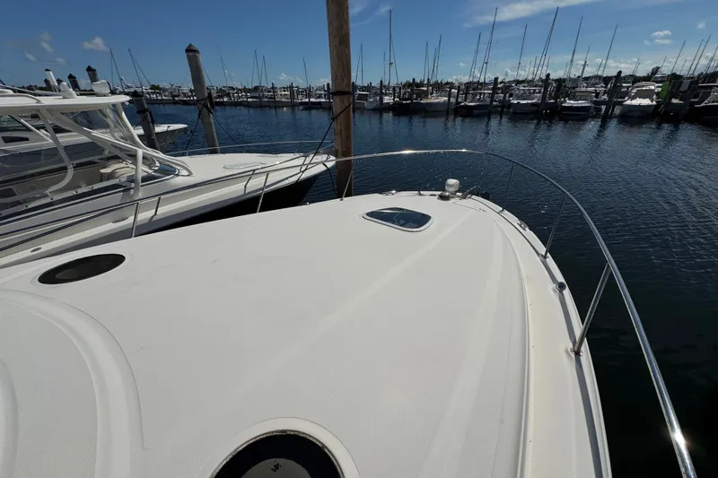 Slide: The Image of 2006 Sea Ray 340 Sundancer docked at marina, surrounded by other boats. - 50