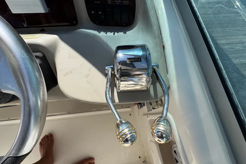 Slide: The Image of Throttle controls on a 2006 Sea Ray 340 Sundancer boat cockpit. - 43
