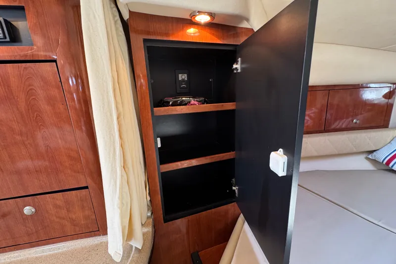 Slide: The Image of Interior of a 2006 Sea Ray 340 Sundancer with open wooden cabinet and shelves. - 96