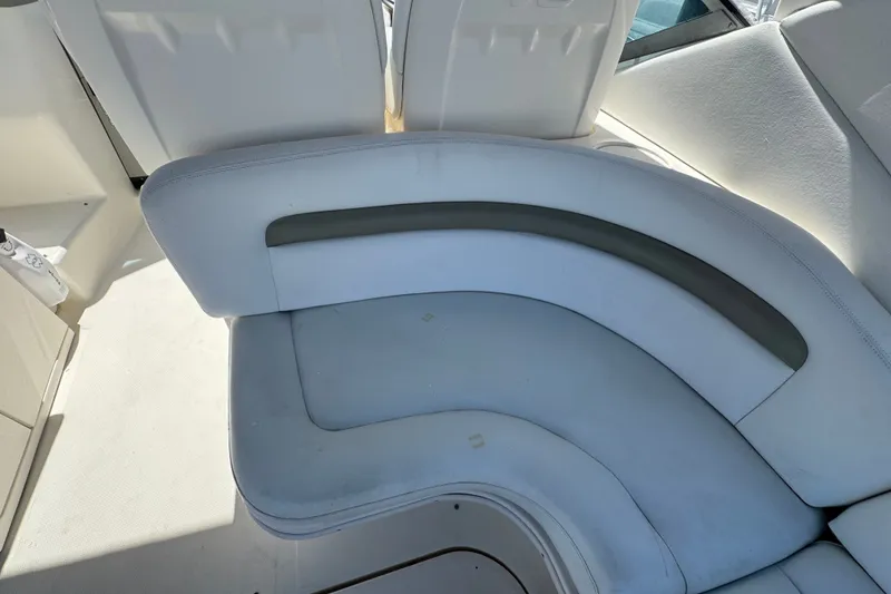Slide: The Image of 2006 Sea Ray 340 Sundancer boat interior seating, featuring white and gray upholstery. - 22