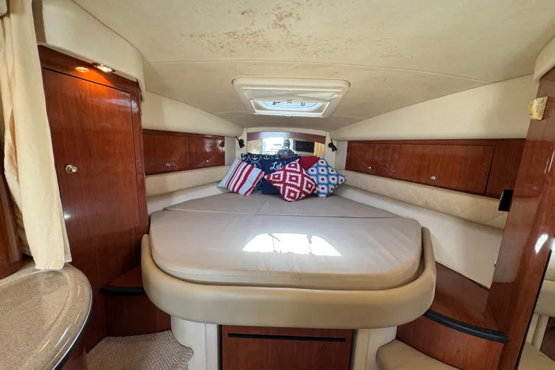 Slide: The Image of Interior cabin of 2006 Sea Ray 340 Sundancer with cozy bed and decorative pillows. - 65