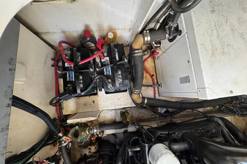 Slide: The Image of Engine compartment of a 2006 Sea Ray 340 Sundancer with batteries and wiring visible. - 104