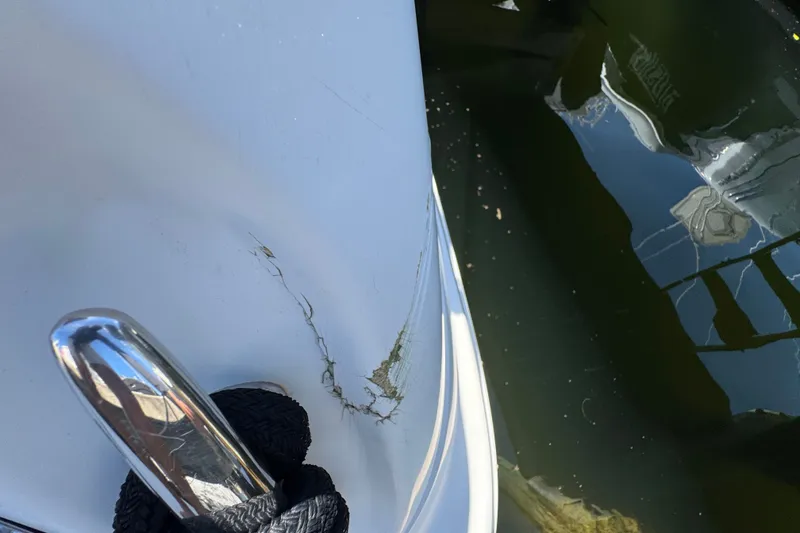 Slide: The Image of Close-up of 2006 Sea Ray 340 Sundancer with visible hull damage near waterline. - 13