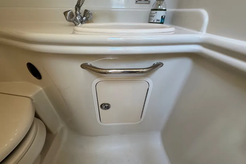 Slide: The Image of 2006 Sea Ray 340 Sundancer bathroom sink with faucet and storage compartment. - 82