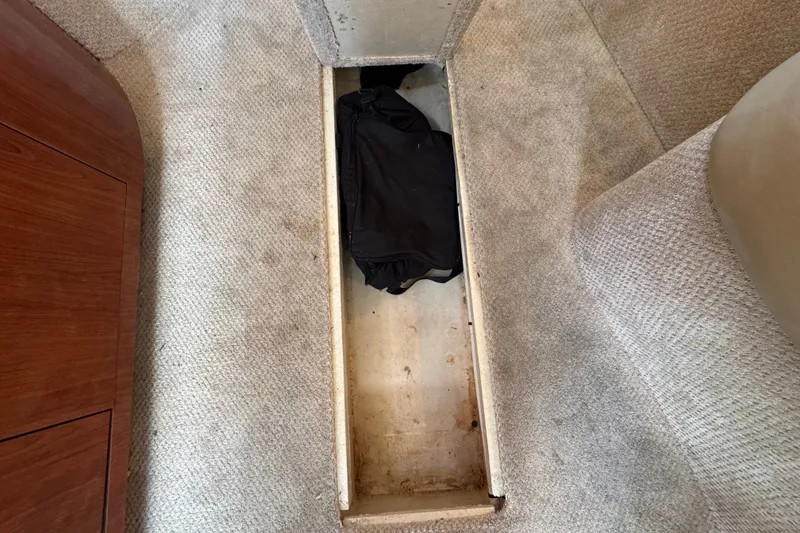 Slide: The Image of Storage compartment in 2006 Sea Ray 340 Sundancer boat, featuring carpeted interior. - 98