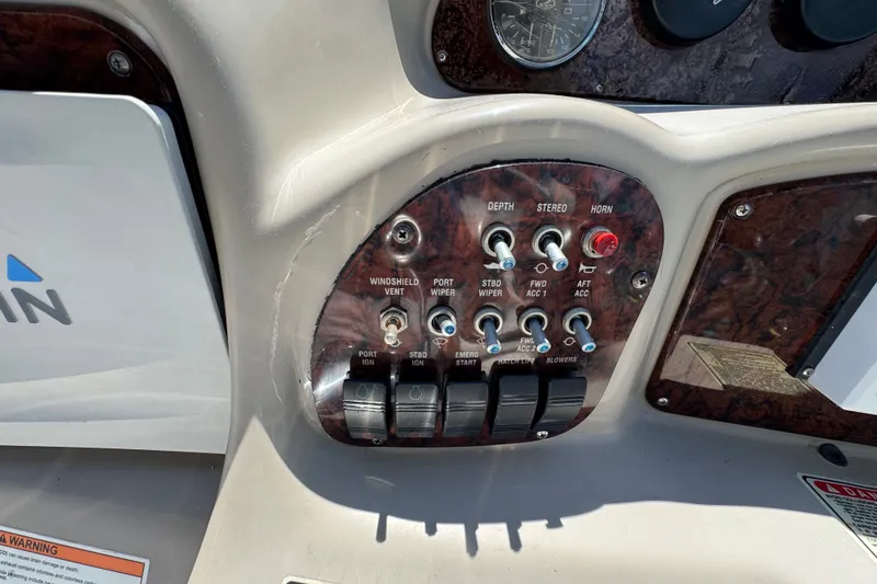 Slide: The Image of Control panel of a 2006 Sea Ray 340 Sundancer boat with various switches and gauges. - 39
