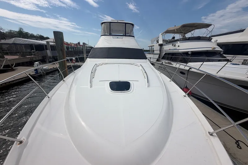 Slide: The Image of 2006 Sea Ray 550 Sedan Bridge yacht docked at marina under blue sky. - 33