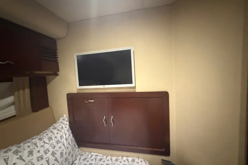 Slide: The Image of Interior of 2006 Sea Ray 550 Sedan Bridge with TV and wooden cabinet. - 100