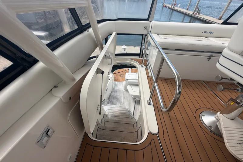 Slide: The Image of 2006 Sea Ray 550 Sedan Bridge interior with stairs, teak flooring, and seating area. - 61