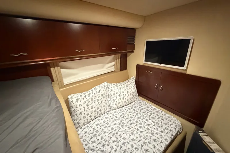 Slide: The Image of Cozy cabin interior of 2006 Sea Ray 550 Sedan Bridge with bed and TV. - 128