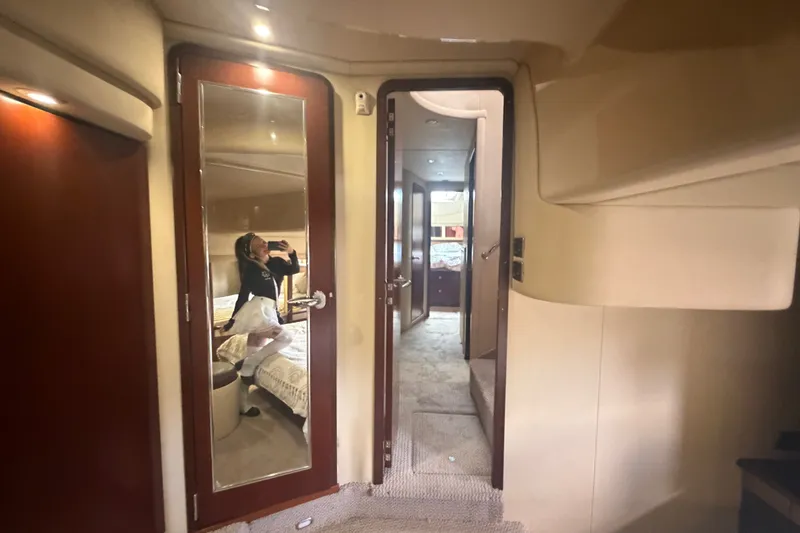 Slide: The Image of Interior of 2006 Sea Ray 550 Sedan Bridge yacht, featuring luxurious cabin hallway. - 93