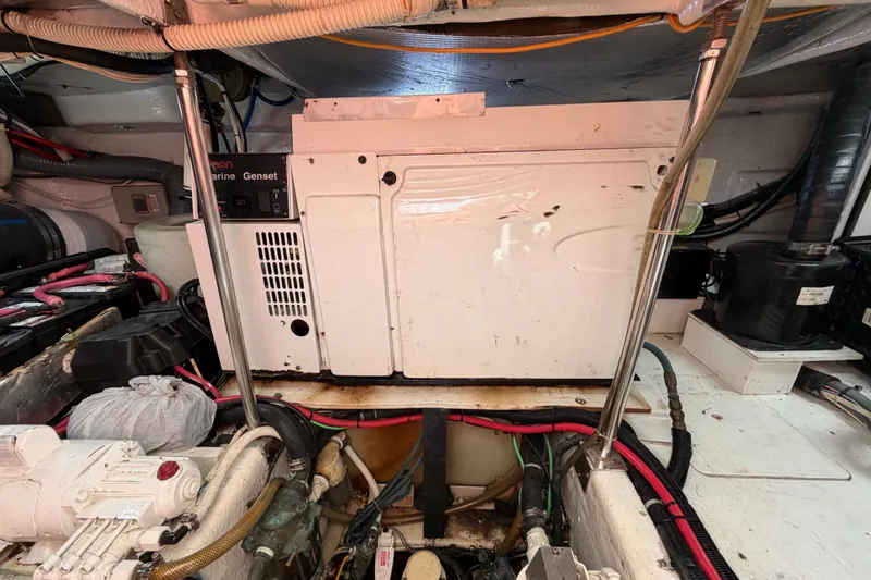 Slide: The Image of Engine room of 2006 Sea Ray 550 Sedan Bridge with marine generator and wiring. - 140