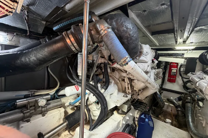 Slide: The Image of Engine room of a 2006 Sea Ray 550 Sedan Bridge yacht, showcasing mechanical components. - 143