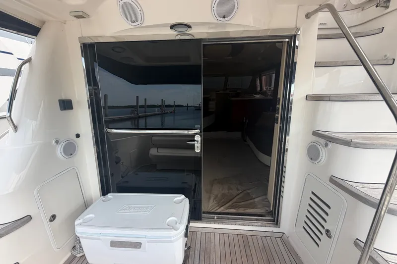 Slide: The Image of 2006 Sea Ray 550 Sedan Bridge yacht interior with sliding glass door and staircase. - 49