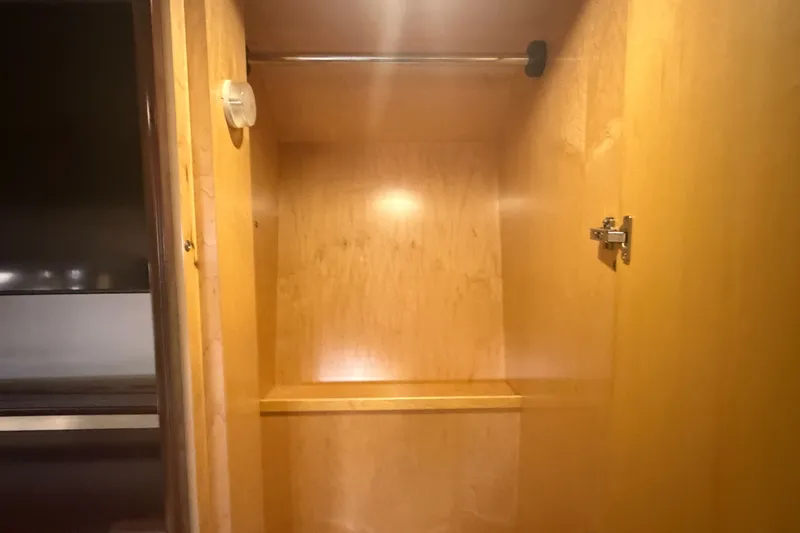 Slide: The Image of Wooden closet interior on a 2006 Sea Ray 550 Sedan Bridge yacht. - 90