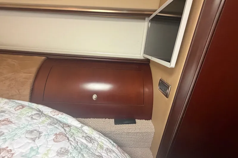 Slide: The Image of Interior cabin of 2006 Sea Ray 550 Sedan Bridge with wood paneling and TV. - 101