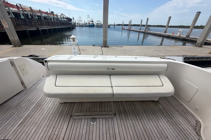 Slide: The Image of 2006 Sea Ray 550 Sedan Bridge yacht with rear seating, docked at a marina. - 46
