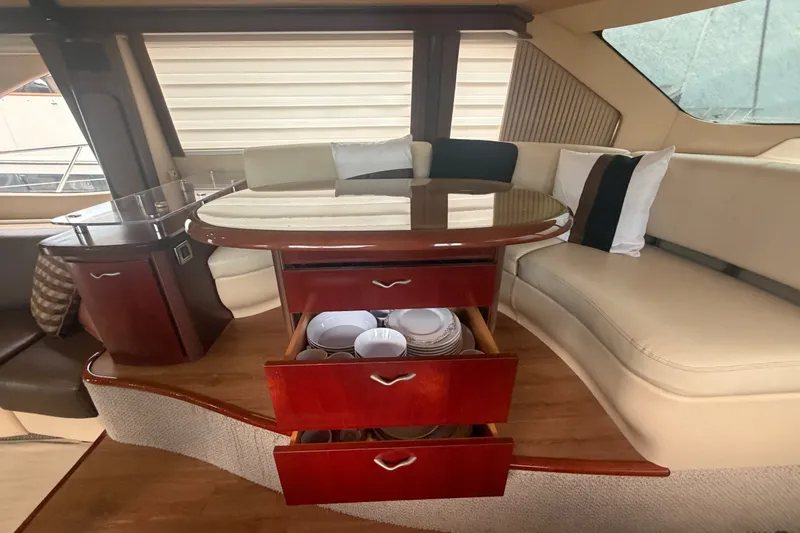 Slide: The Image of Luxurious interior of 2006 Sea Ray 550 Sedan Bridge with elegant seating and storage. - 71