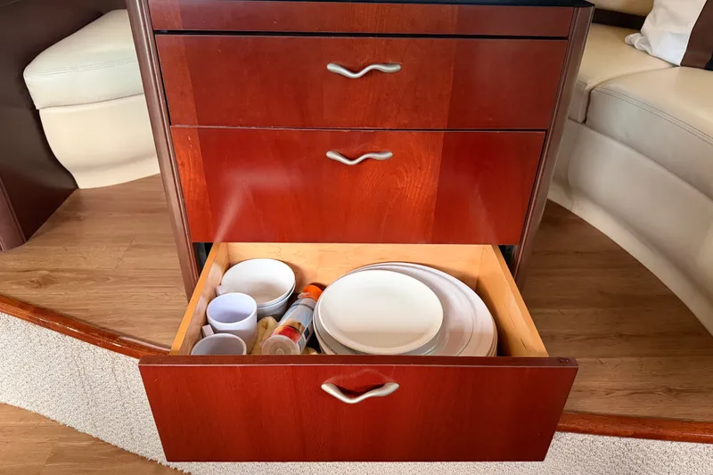 Slide: The Image of Open drawer with dishes and cups in a 2006 Sea Ray 550 Sedan Bridge yacht. - 109