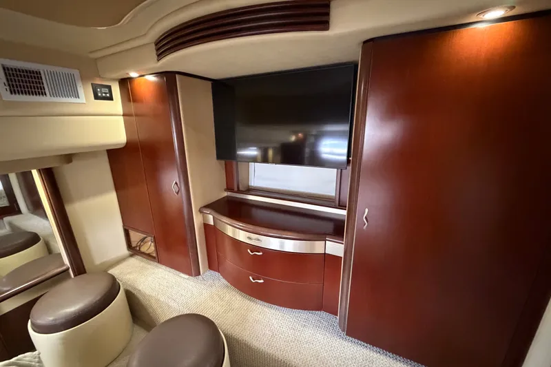 Slide: The Image of Luxurious interior of 2006 Sea Ray 550 Sedan Bridge yacht with wood cabinetry and TV. - 123