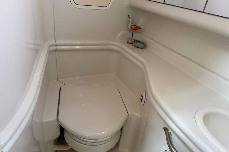 Slide: The Image of 2006 Sea Ray Sundancer 320 boat bathroom with compact toilet and sink. - 69