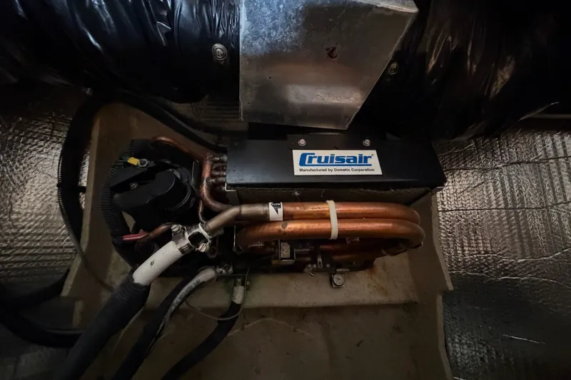 Slide: The Image of Cruisair unit in 2006 Sea Ray Sundancer 320 engine compartment, showcasing copper piping and insulation. - 100