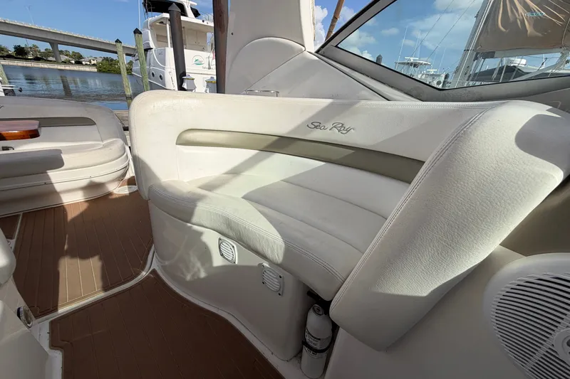 Slide: The Image of Interior seating of a 2006 Sea Ray Sundancer 320 boat, featuring white upholstery. - 50