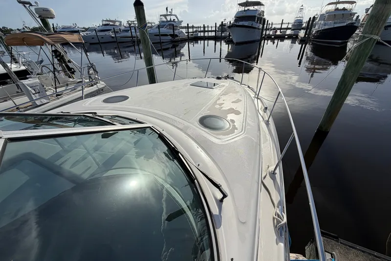 Slide: The Image of 2006 Sea Ray Sundancer 320 docked at marina with other boats in background. - 17